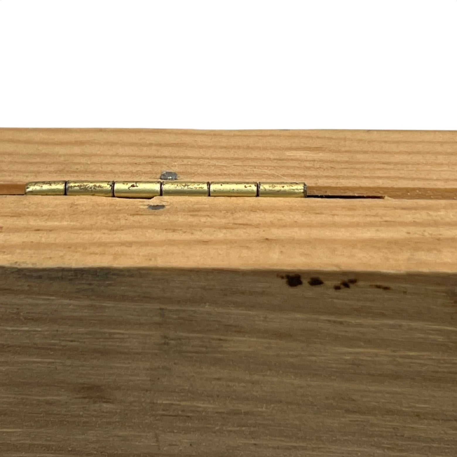 Wooden surface with a brass hinge