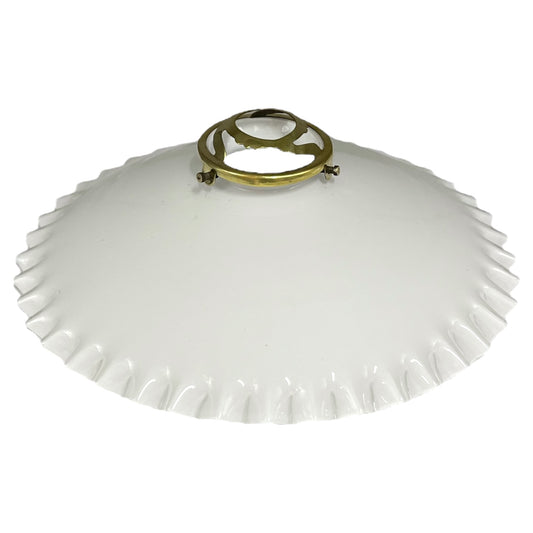 White lampshade with a gold metal fixture on a white background