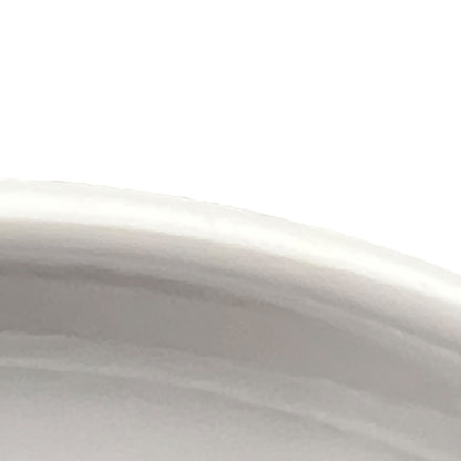 Close-up of a white ceramic bowl with a smooth surface