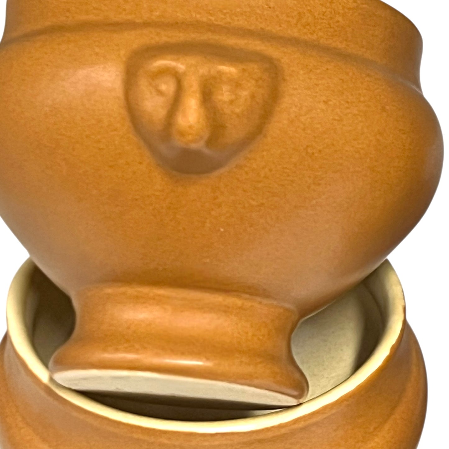 light brown ceramic French soup bowls with lions head handles on a white background