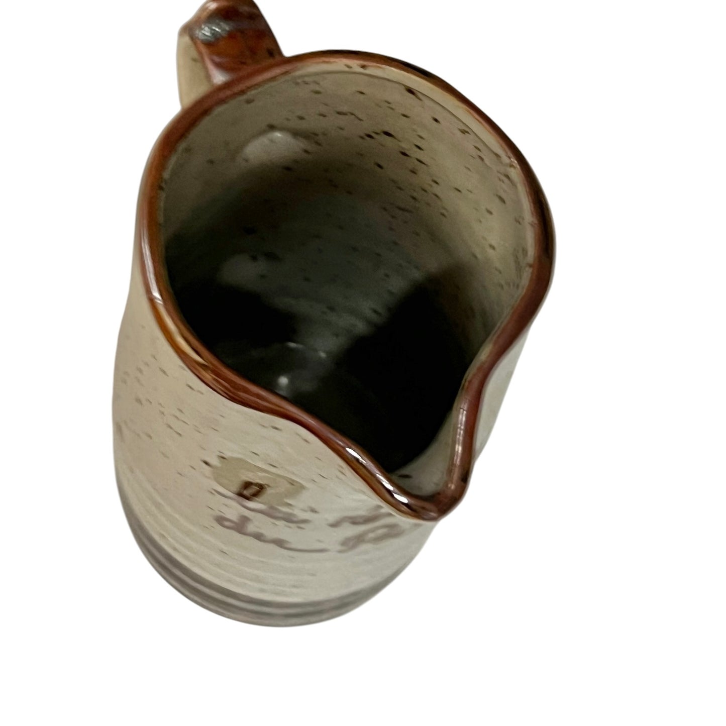 close up of ceramic glazed pitcher jug on a white background 