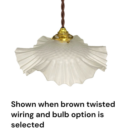 A white pleated glass pendant light shade hanging from a brown twisted cord and gold-toned fixture, with text below stating it is shown when brown twisted wiring and bulb option is selected.