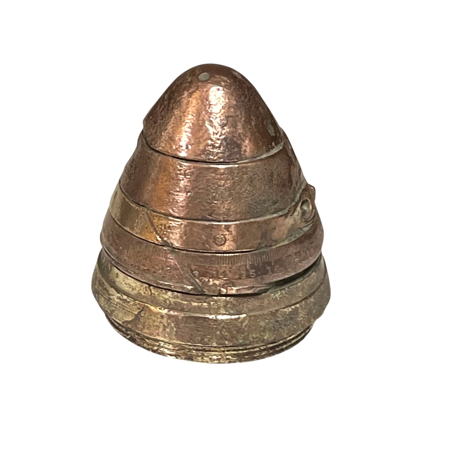 WW1 brass fuse now repurposed as a paperweight, with markings for identification of wear, on a white background