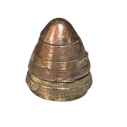 WW1 brass fuse now repurposed as a paperweight, with markings for identification of wear, on a white background