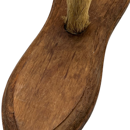 Close up of taxidermy deer hooves on a wooden mount on a white background