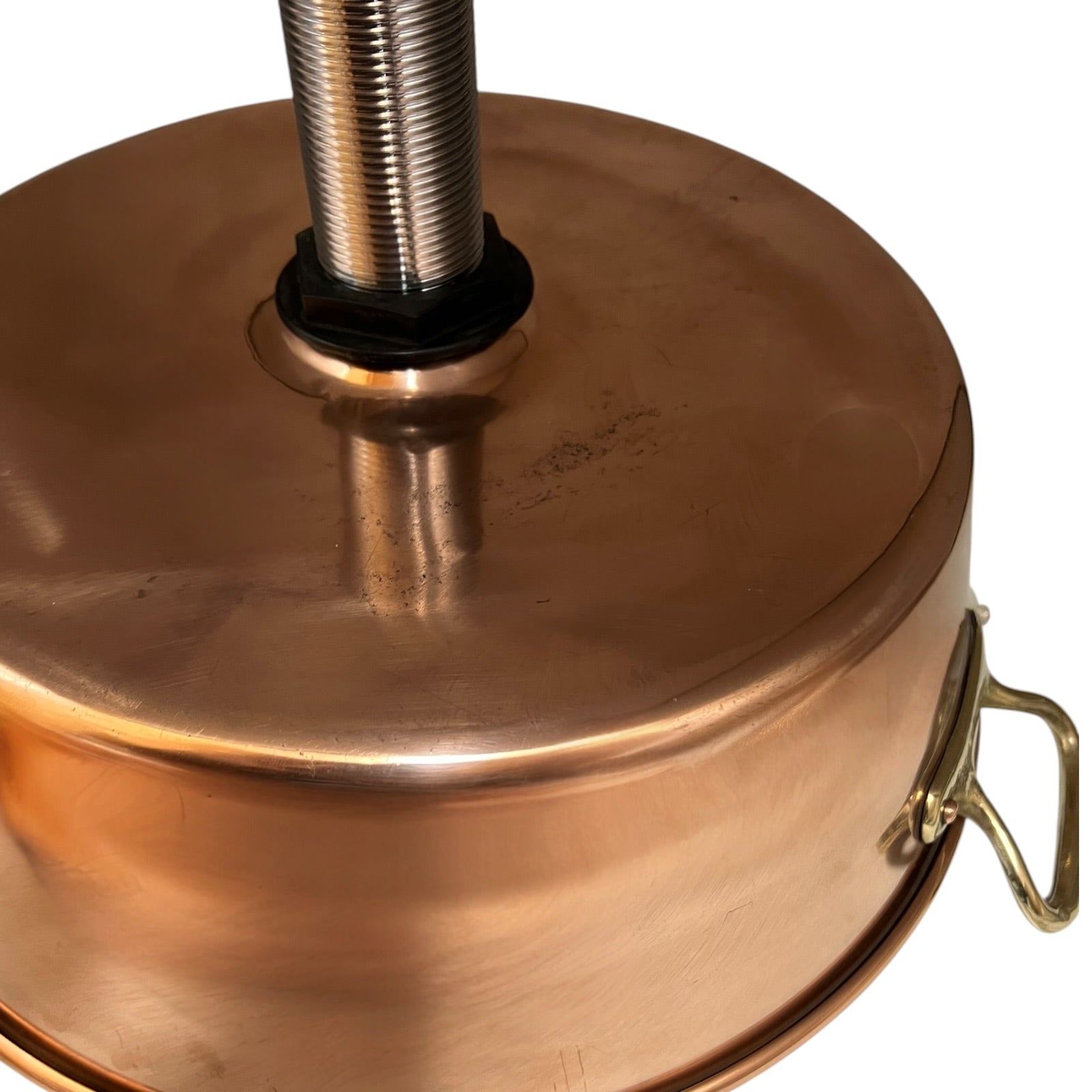 Close-up of a copper sink with a drain plug