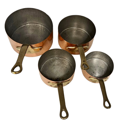 Close-up of a copper pot with a brass handle on a white background