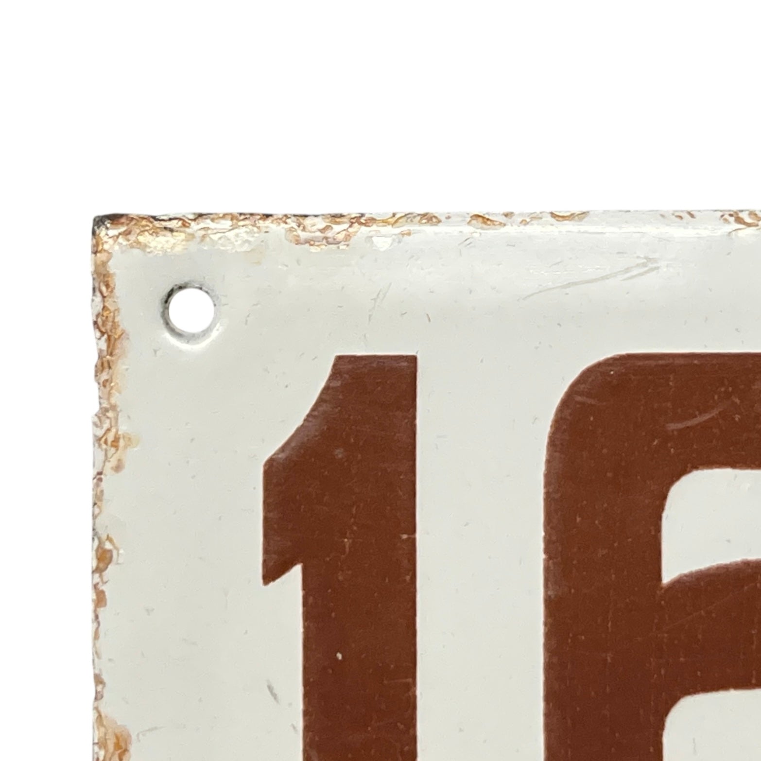 Close-up of a vintage-style number '162' on a white background