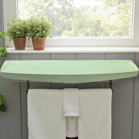 Pale green ceramic shelf mounted on a grey wall above a towel rail and a window in a rustic bathroom for sale by All Things French Store with towels and plants in a home setting