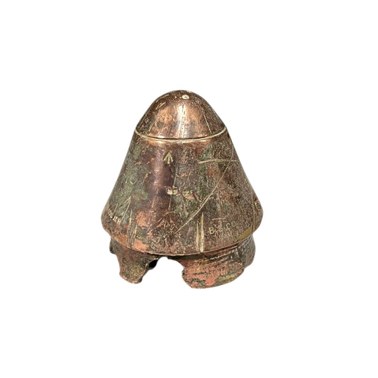 WW1 British brass fuse now repurposed as a paperweight on a white background