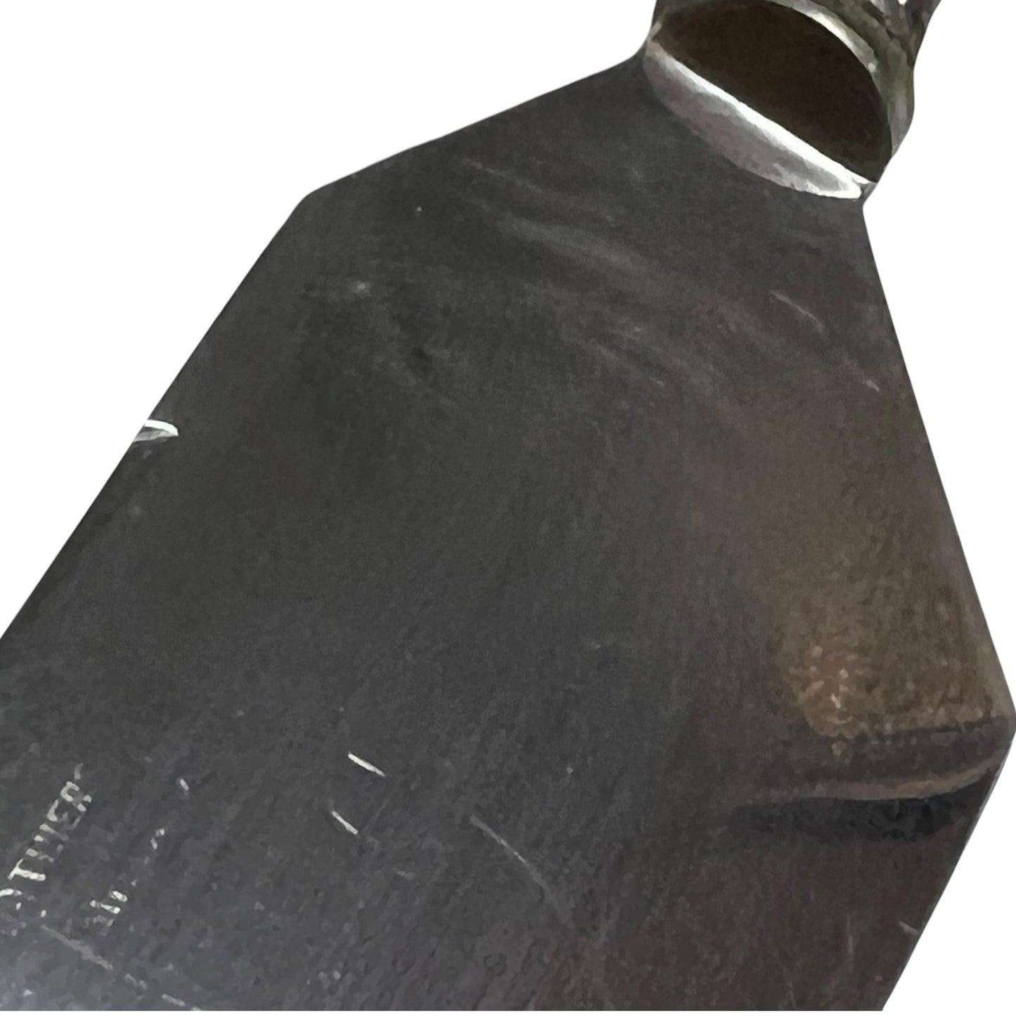 A close-up of a dark metal blade or tool head with a polished silver collar, shown against a plain white background.