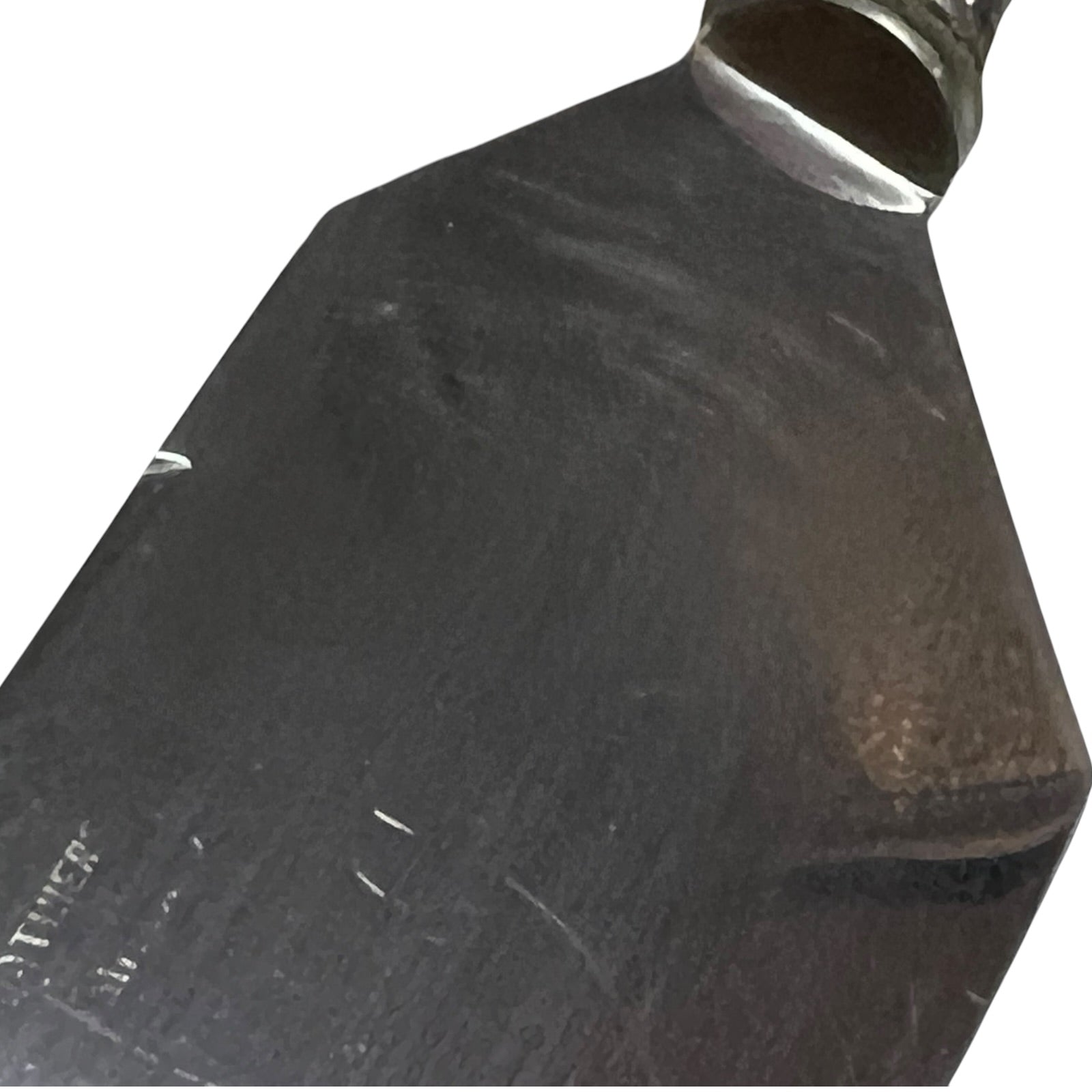 A close-up of a dark metal blade or tool head with a polished silver collar, shown against a plain white background.