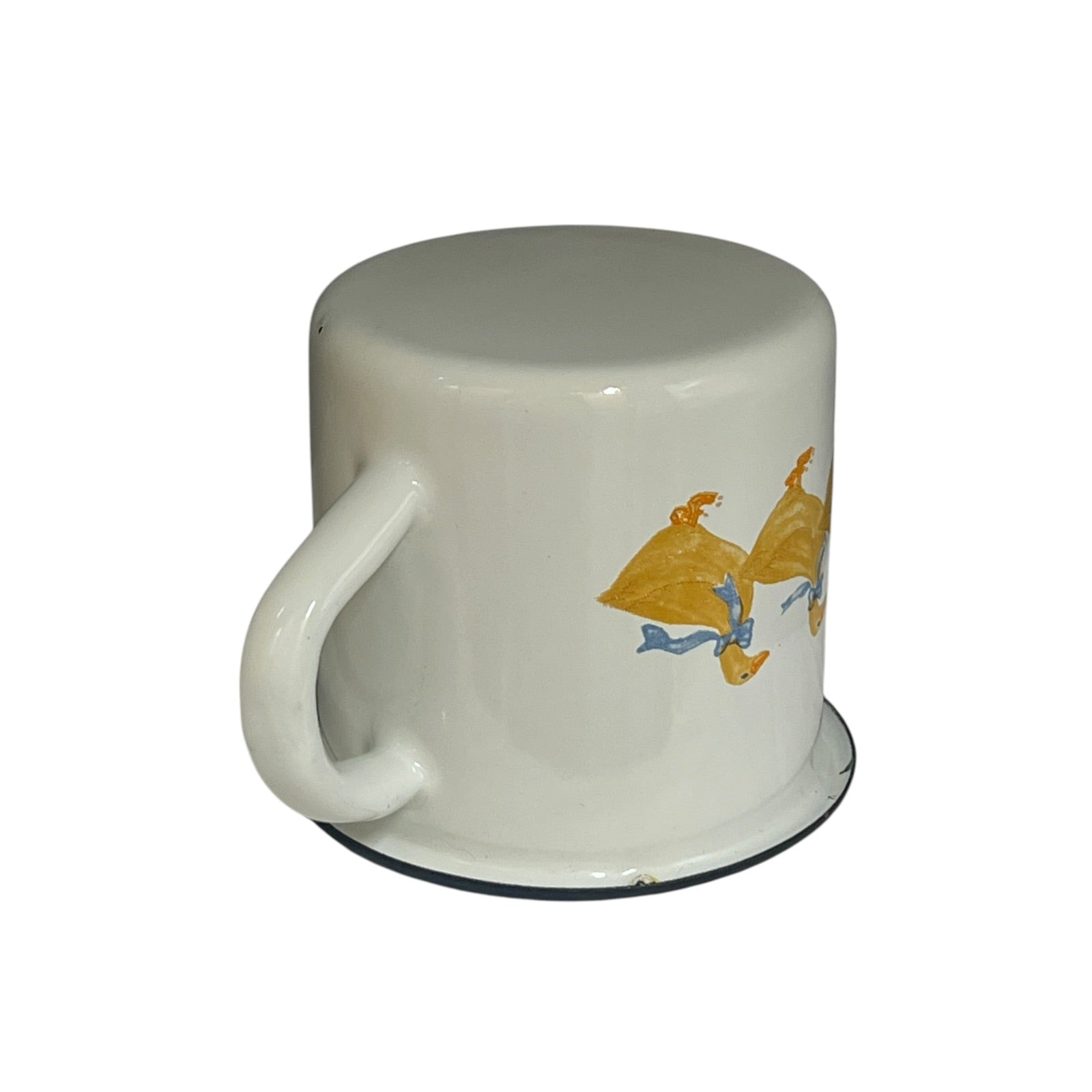 Close up of a white enamel milk churn and mug with duck design on a white background
