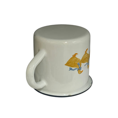 Close up of a white enamel milk churn and mug with duck design on a white background