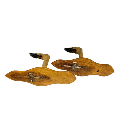 Two vintage wooden mounted deer hooves, displayed on a plain white background.