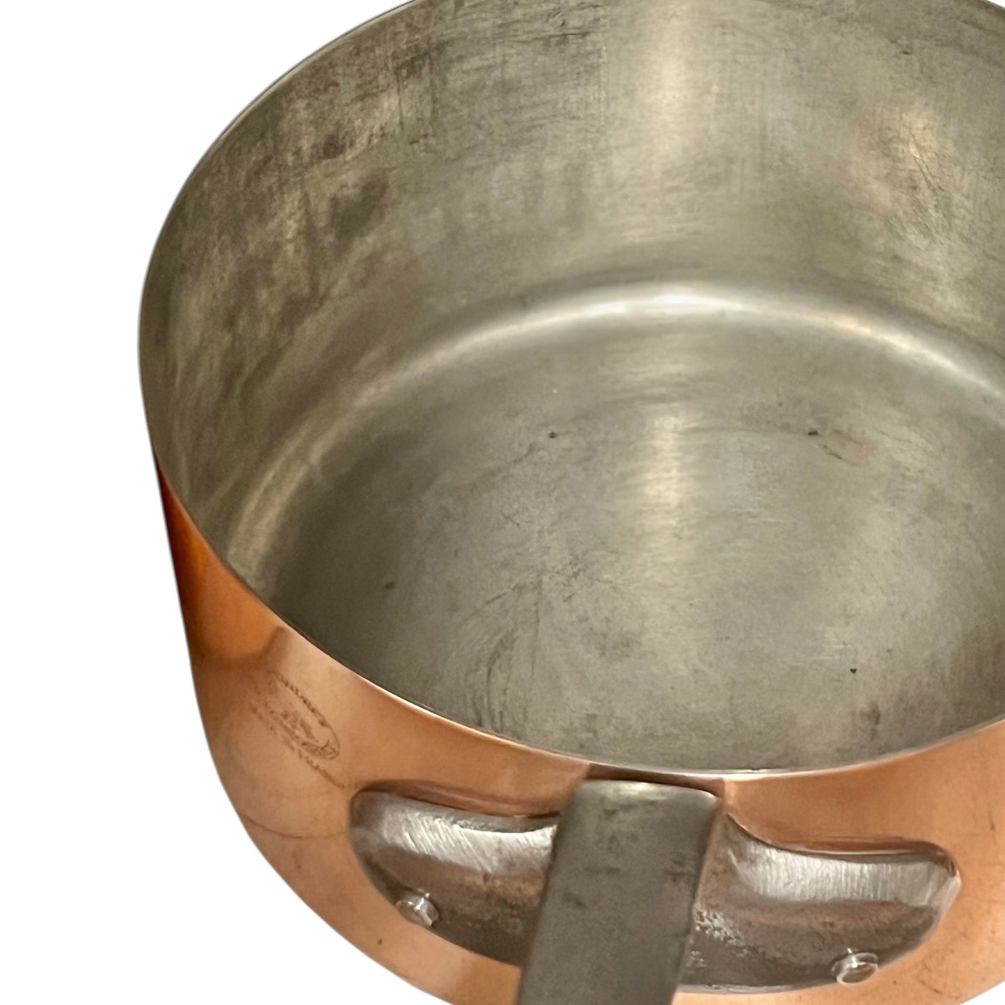 Close-up of copper cookware with iron handles on a white background
