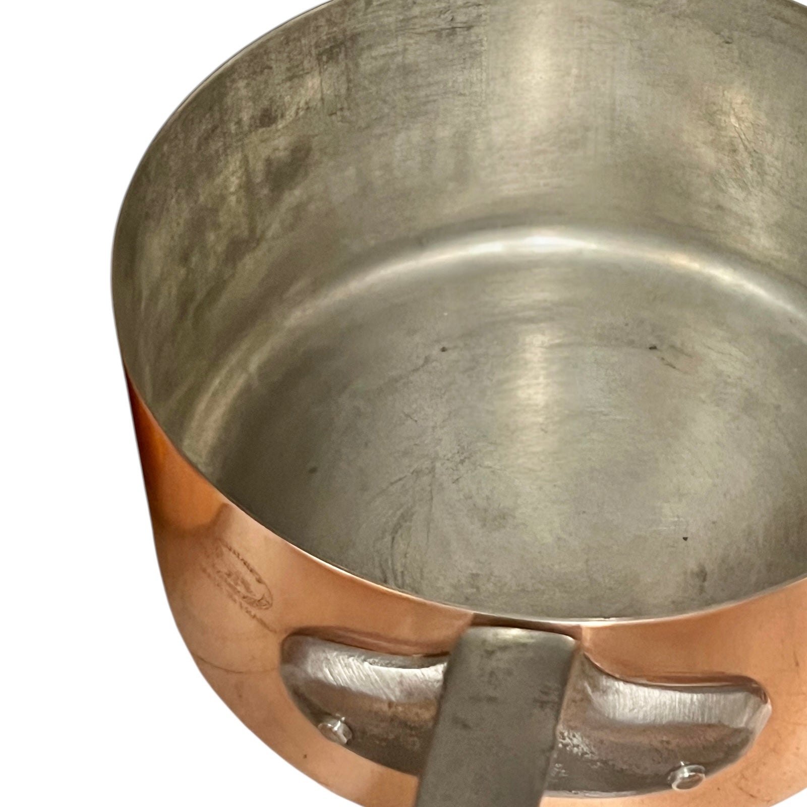 Close-up of copper cookware with iron handles on a white background