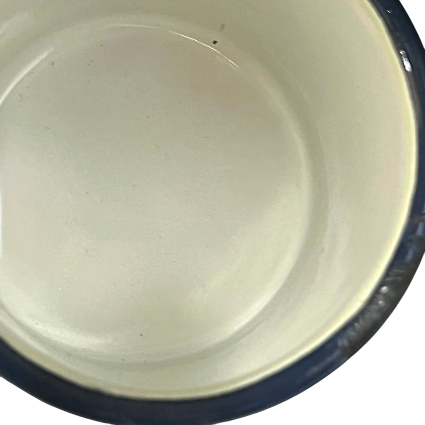Close up of a white enamel milk churn and mug with duck design on a white background