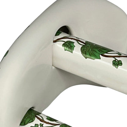 White and green leaf patterned towel rails on a white background