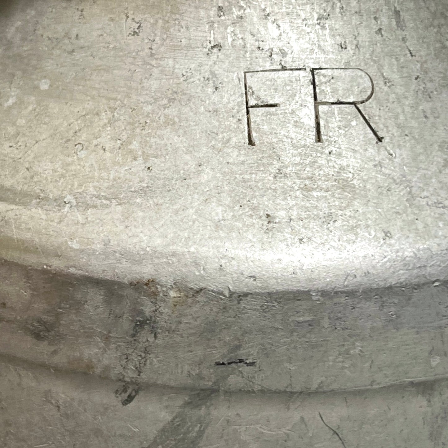 Close up of a vintage metal milk churn on a white background