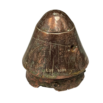 WW1 British brass fuse now repurposed as a paperweight on a white background
