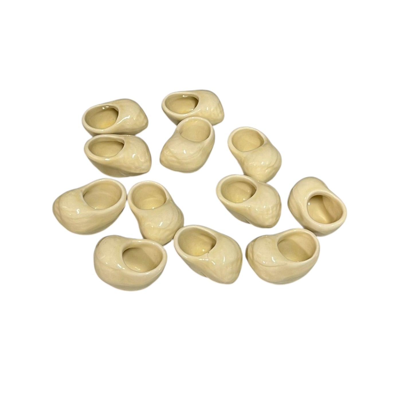 Set of 12 ceramic French escargot cups shaped like snails ideal for a restaurant or a keen French cook, set on a white background
