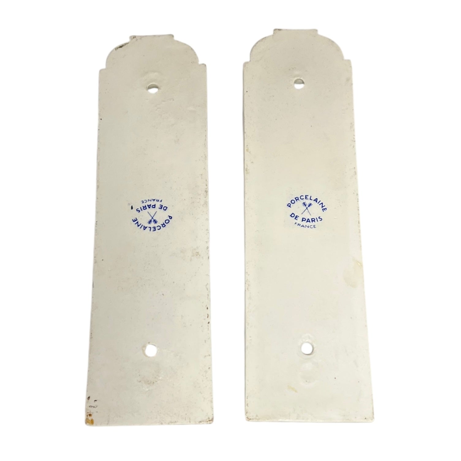Close up of the back of a pair of finger push plates on a white background
