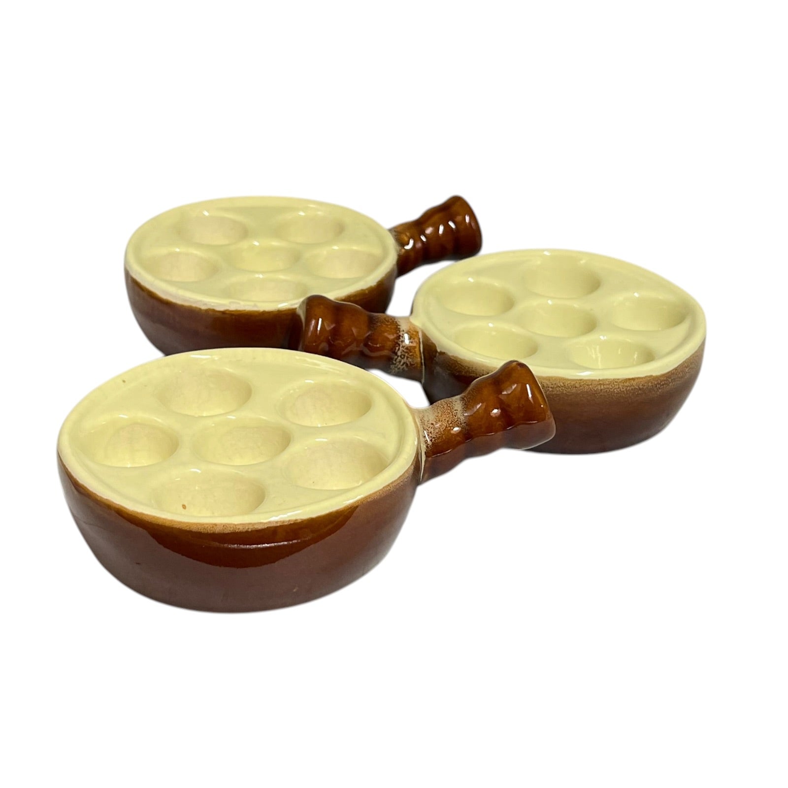 Three small ceramic snail plates with six wells and brown handles, shown on a plain white background
