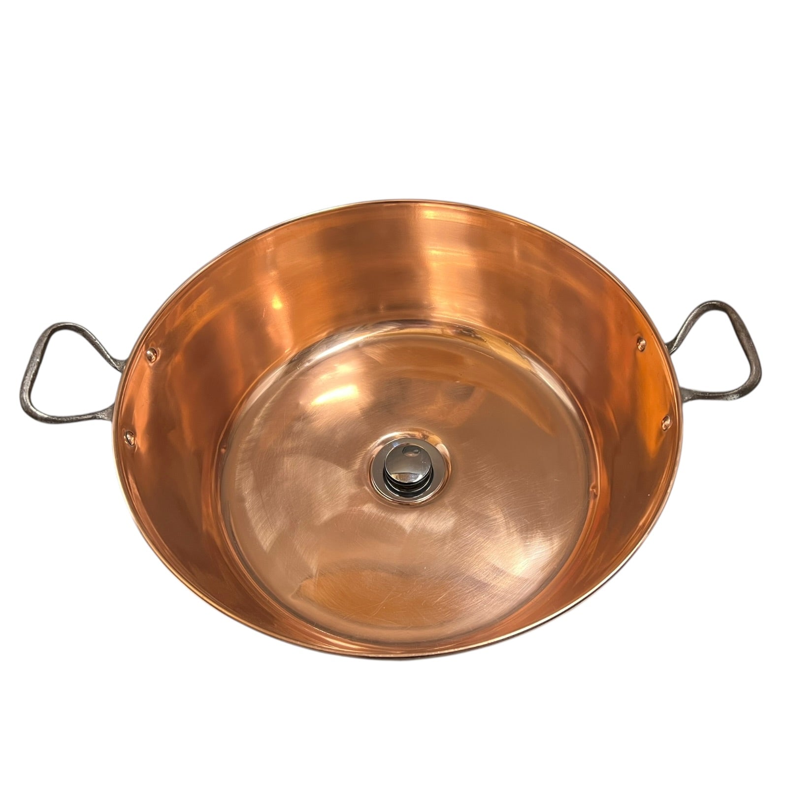 Copper bathroom sink up cycled from a French jam pan on a white background