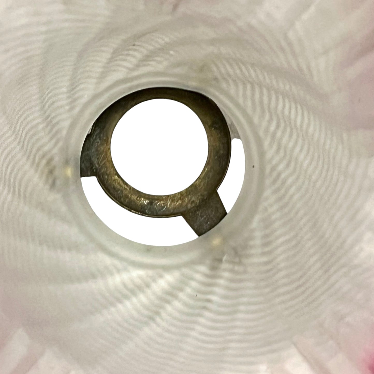 Close-up of a lamp shade interior on a textured white background