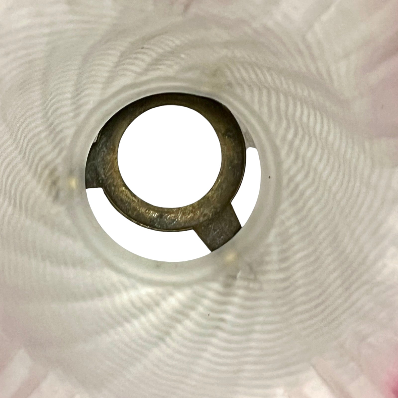Close-up of a lamp shade interior on a textured white background
