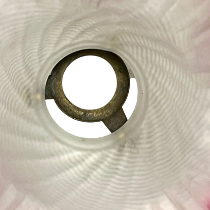 Close-up of a lamp shade interior on a textured white background
