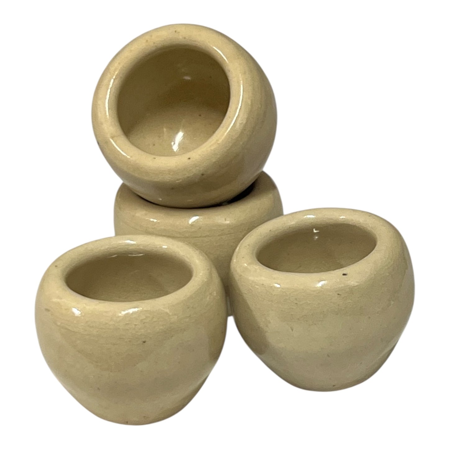 Set of beige ceramic escargots snail cups on a white background