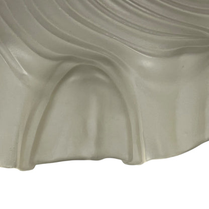 Close up of a vintage-style light fixture with frosted glass shade on a white background