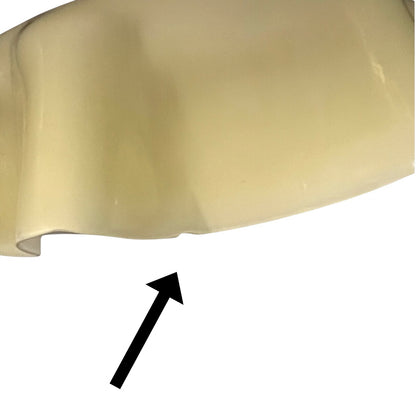 Close-up of a yellow glass shade showing a chip on a white background