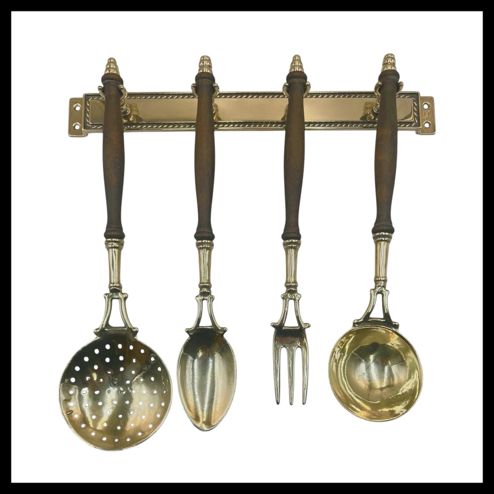 French brass and wooden 4 piece utensil set hanging from a brass bar