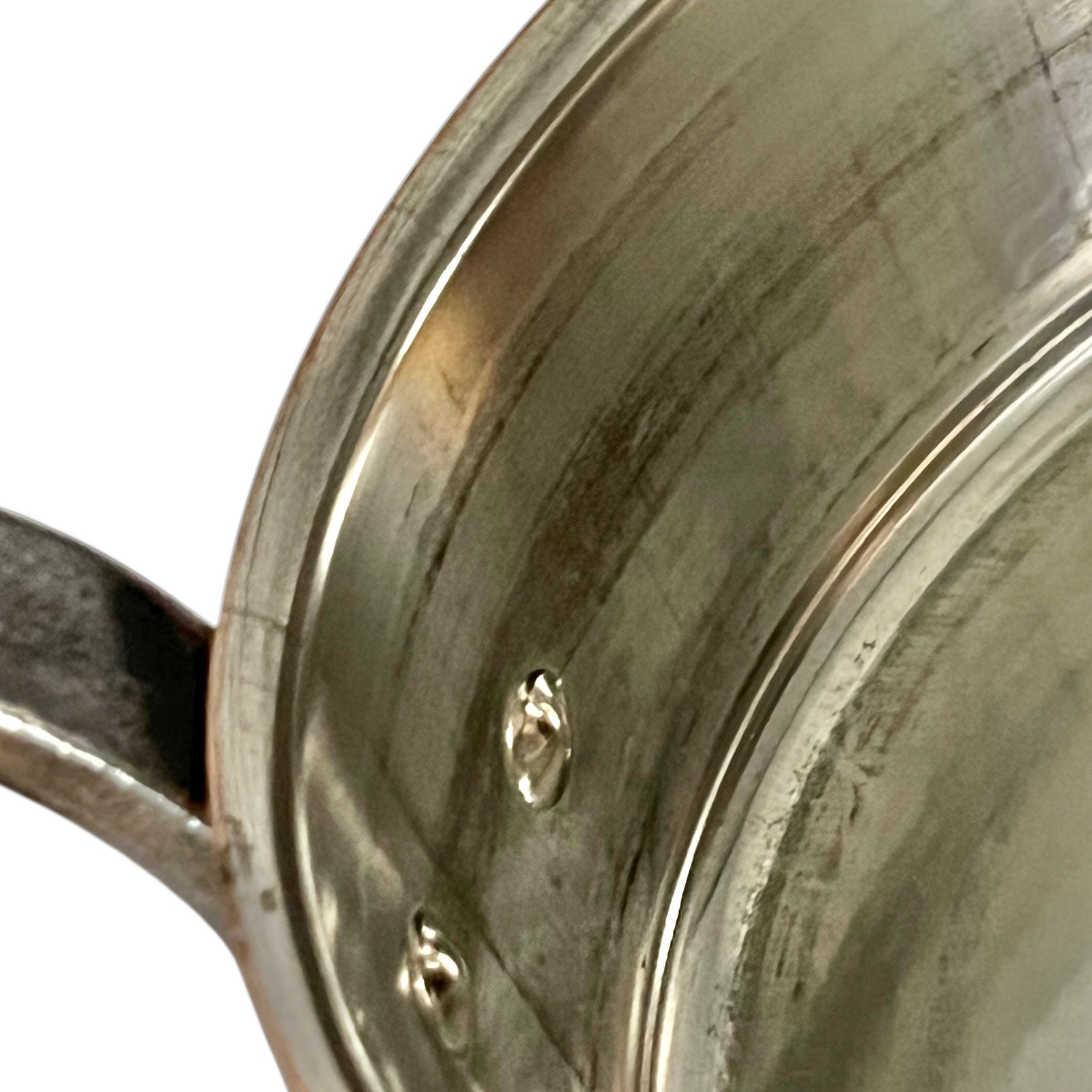inside of copper pan with tin lining on a white background
