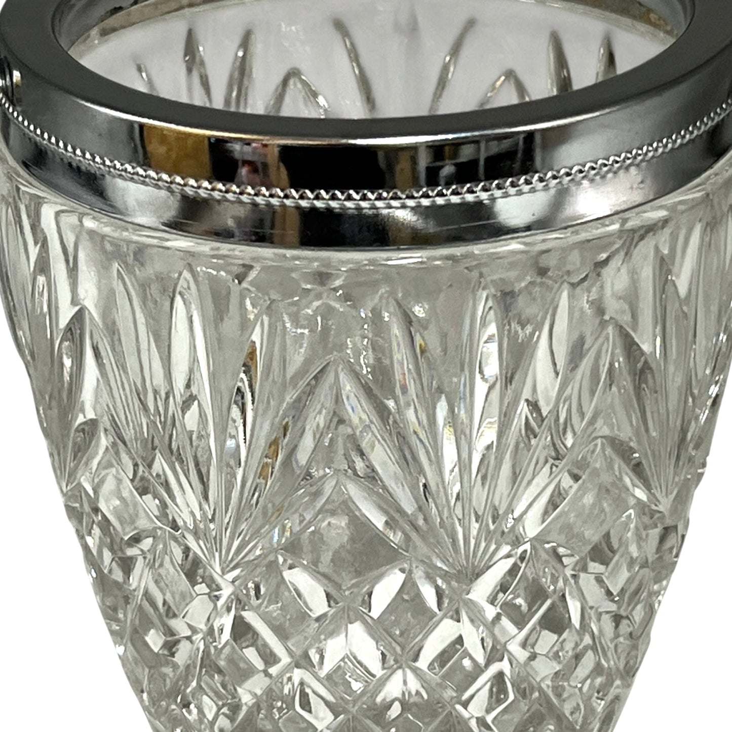 Close up of a French vintage glass ice bucket with silver rim on a white background