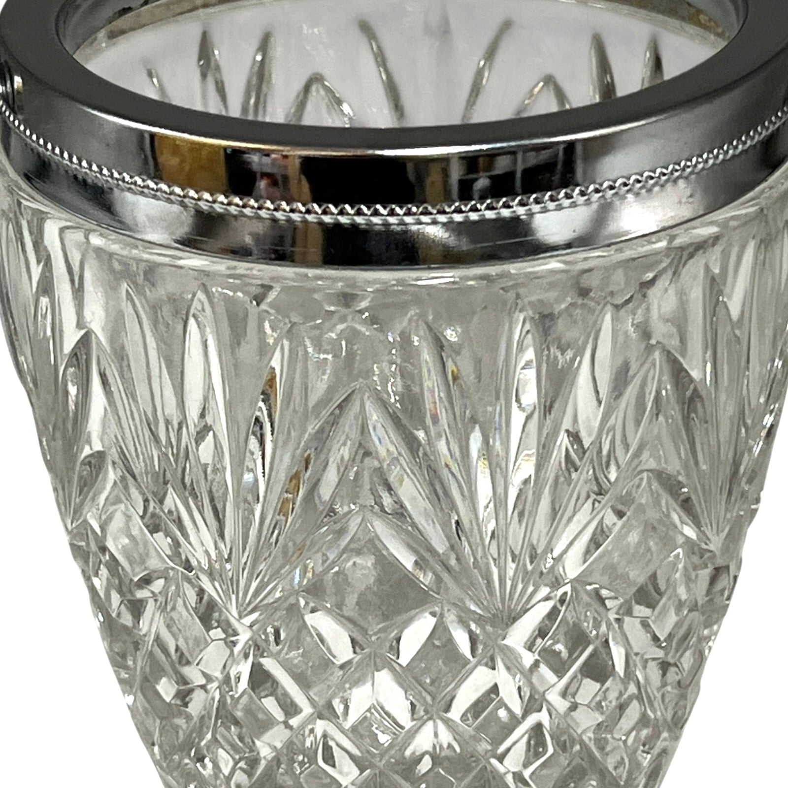 Close up of a French vintage glass ice bucket with silver rim on a white background