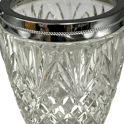 Close up of a French vintage glass ice bucket with silver rim on a white background