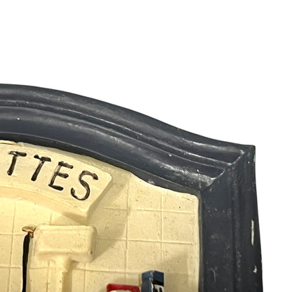 Close-up of a toilet door sign on a white background