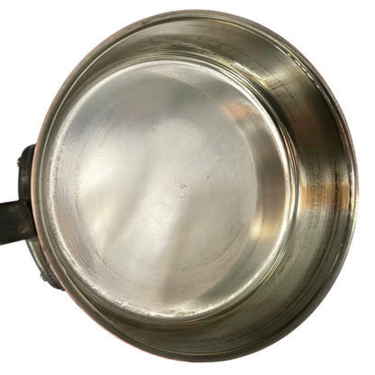 inside of copper pan with tin lining on a white background