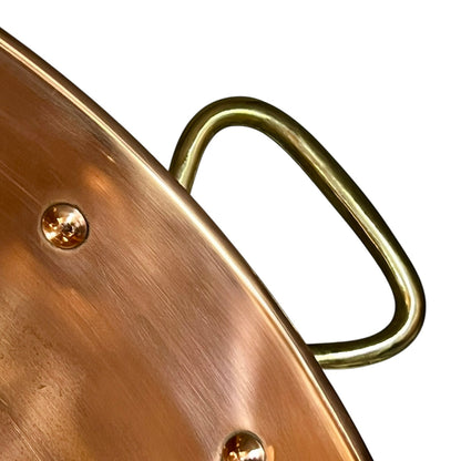 Close-up of a copper sink with a drain plug
