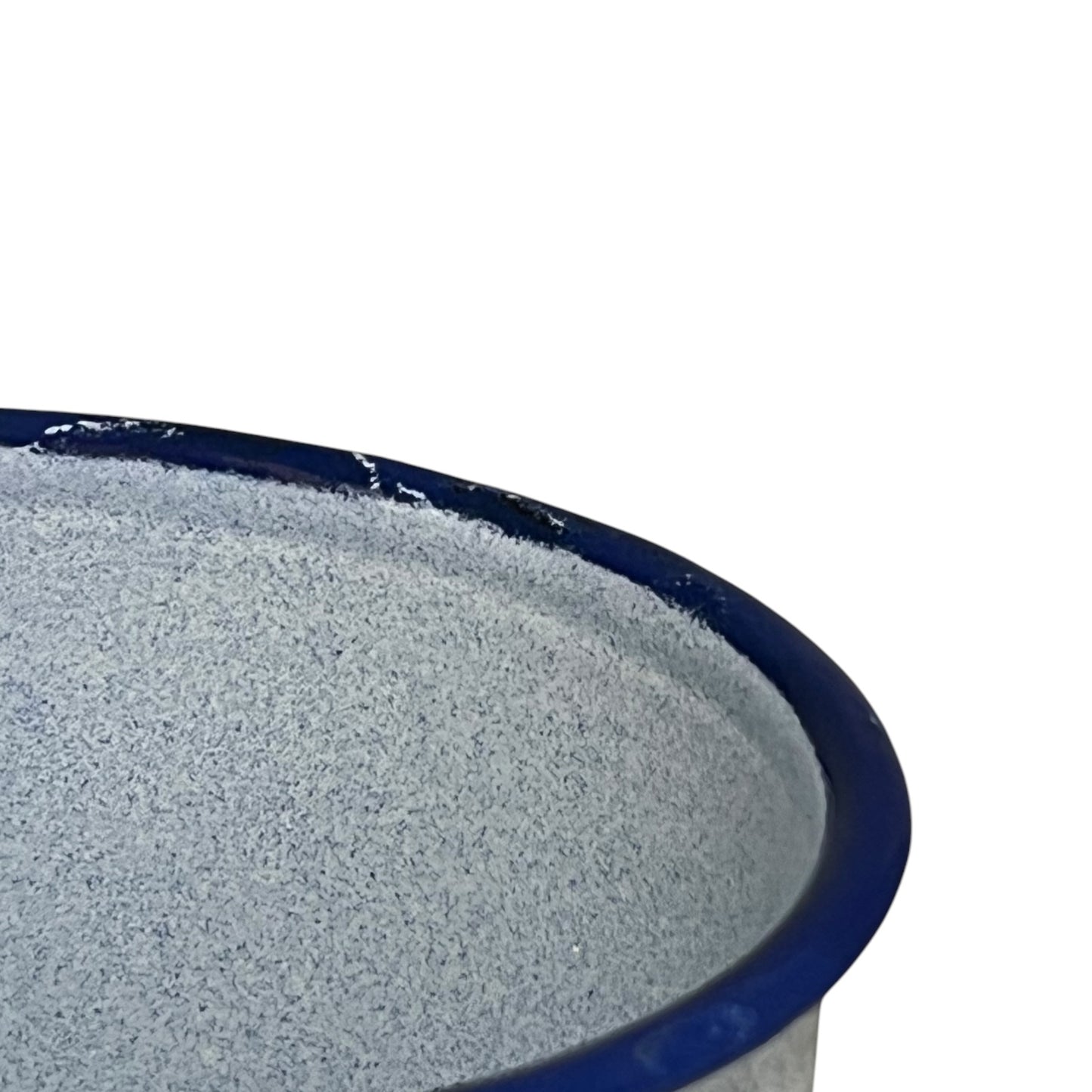 close up of a blue speckled French vintage enamel irrigator rim