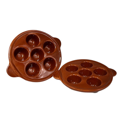 Brown ceramic egg ,snail, or escargots plates with multiple compartments on a white background