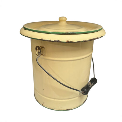 A charming French vintage enamel lidded potty bucket with a wooden handle, featuring a cream finish accented by a green trim. Perfect for use in a farmhouse kitchen as a vegetable or bread bin, or repurposed as a unique garden planter, displayed against a crisp white background.