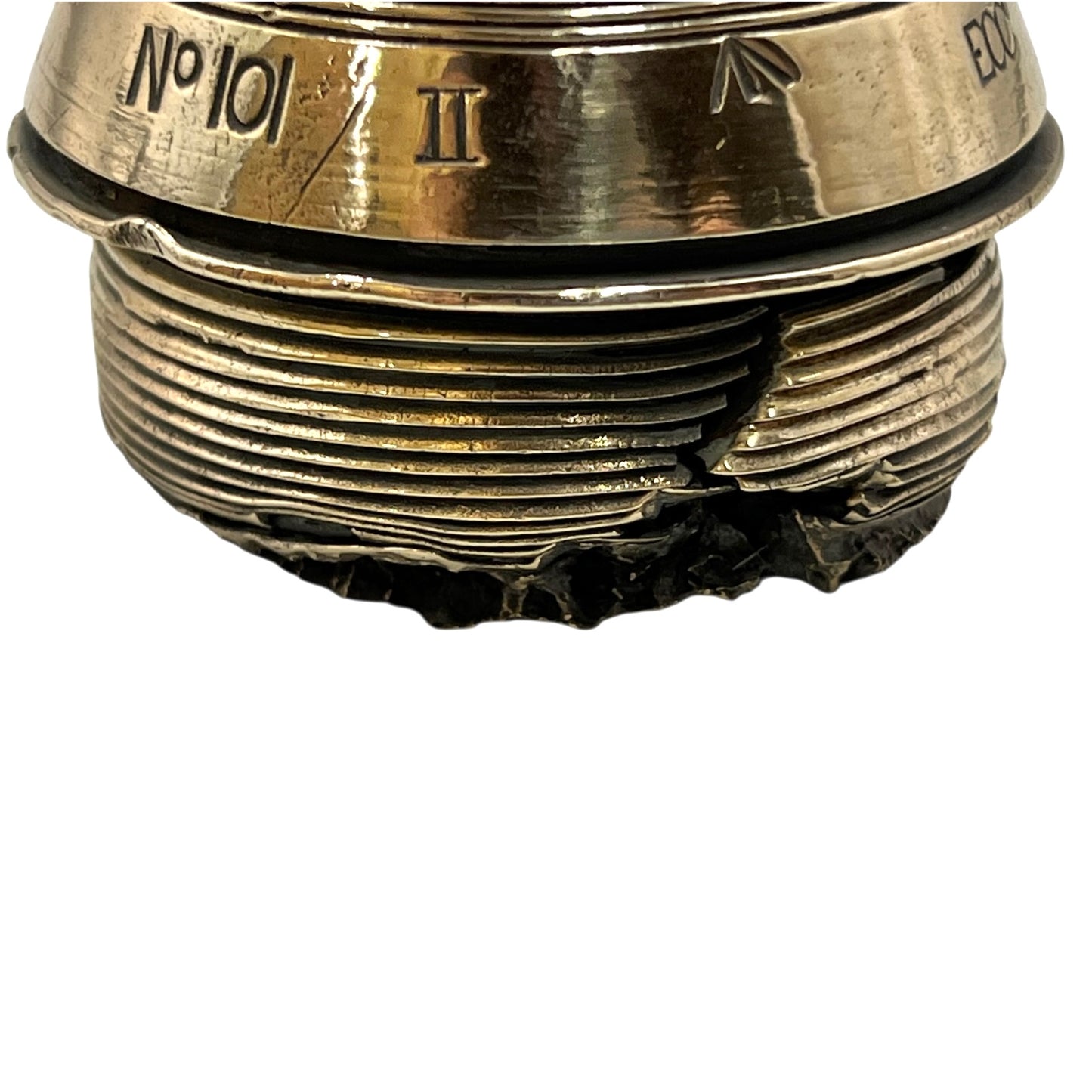 Close up of a polished British brass WW1 fuse or paperweight type 101 on a white background