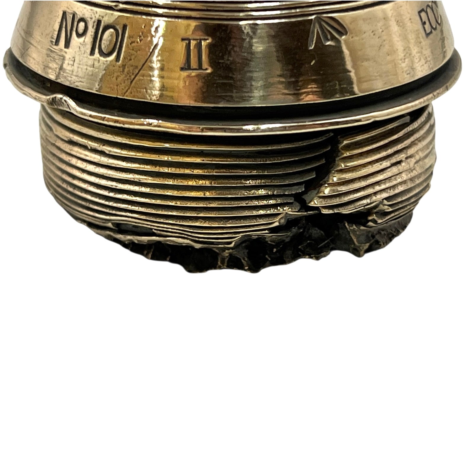 Close up of a polished British brass WW1 fuse or paperweight type 101 on a white background