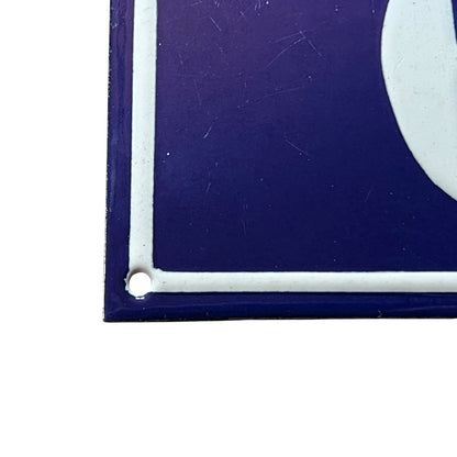 Close-up of a blue surface with a white border and corner dot.