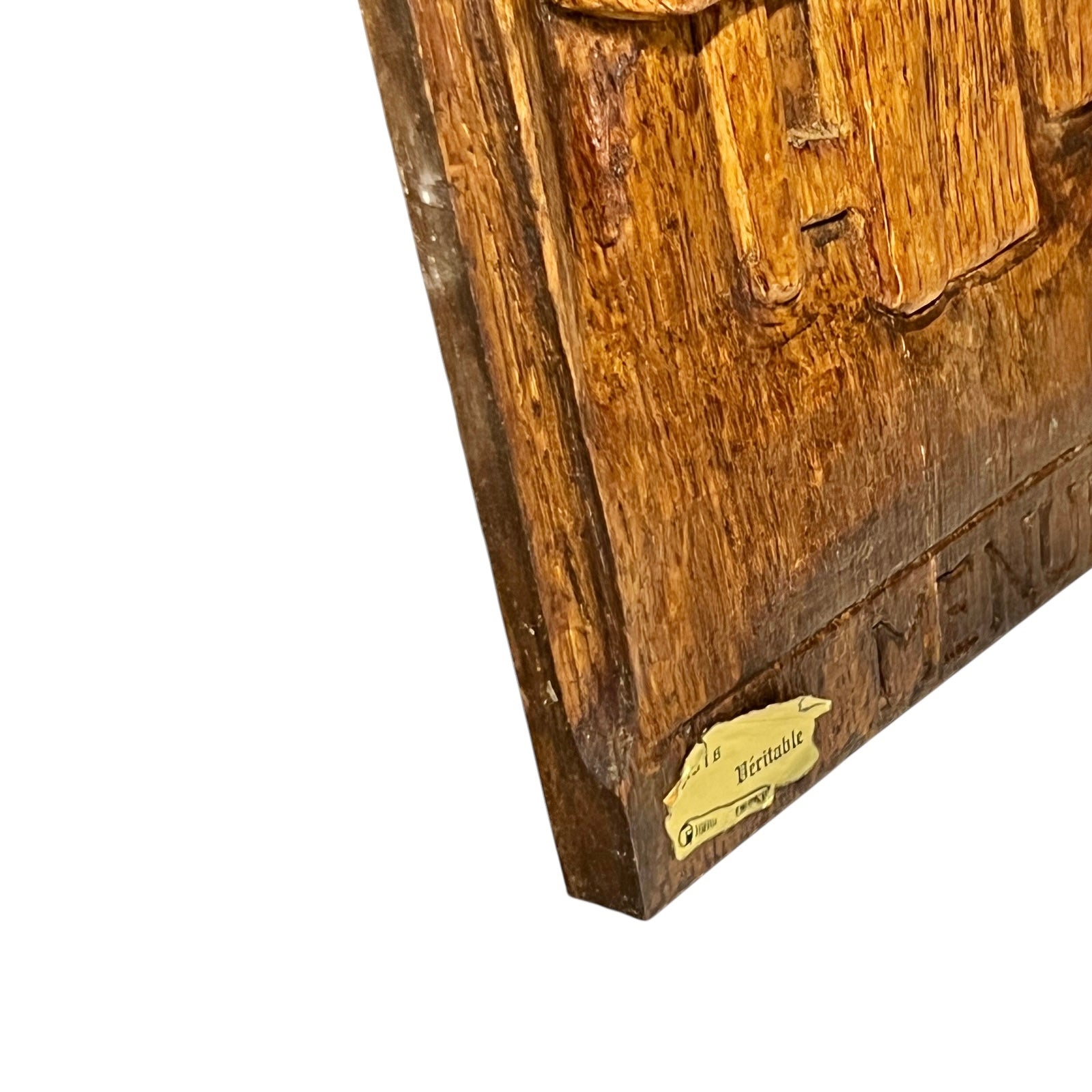 Wooden plaque with engraved text and a gold label on a white background